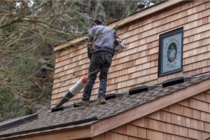 Clarksville Cleaning rain gutter on roof