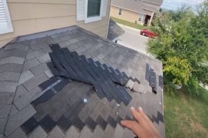 Roof tearing off three tab asphalt shingle for repair