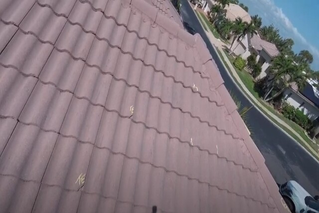 Severe hail and wind damaged markings on tile roof